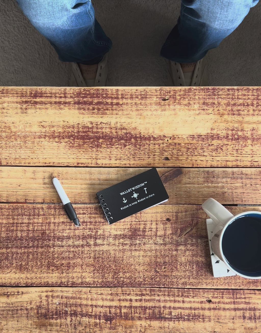 Wallet Wisdom System in action — writing on a wisdom card with a Sharpie alongside the included jotter