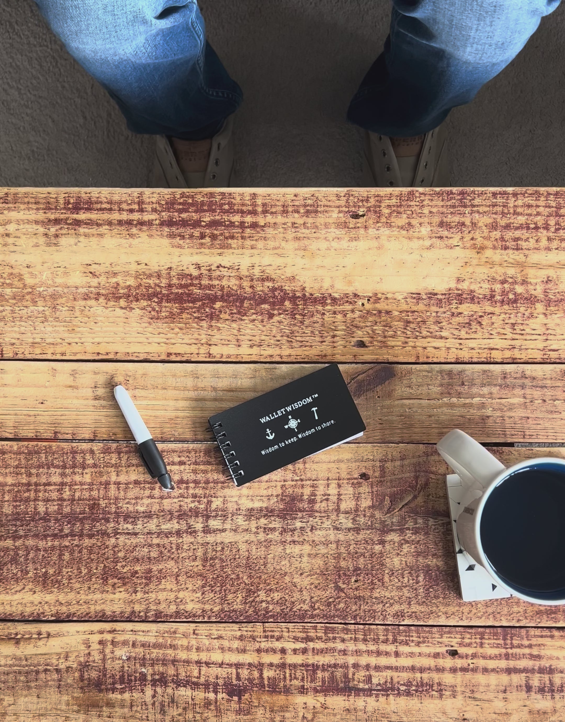 Wallet Wisdom System in action — writing on a wisdom card with a Sharpie alongside the included jotter